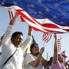 How to Stay in the United States Now That H1B Visas Are At Their Annual Cap American flag at immigration rally